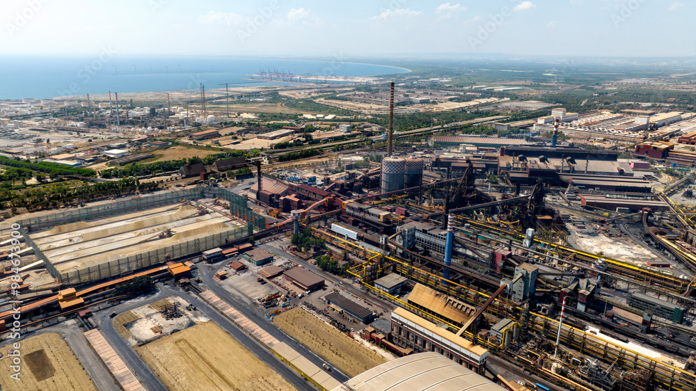 Aerial view of Taranto Steelworks, Italy. The ILVA plant in Taranto is an industrial complex located in the Tamburi district. Aerial view of Taranto Steelworks, Italy. The ILVA plant in Taranto is an industrial complex located in the Tamburi district.