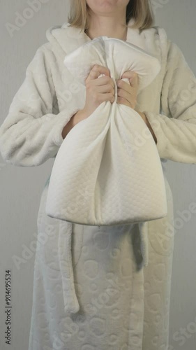 Vertical orientation footage of a woman with memory foam orthopedic pillow for healthy comfort sleeping.