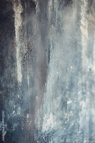 A detailed image of a weathered wall showcasing dark and light patches, capturing the texture and tones vividly. photo