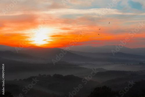 A wonderful view of the sun rays on the mountain at sunrise.