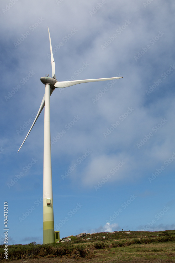 Windmills producing electricity at full capacity with the ocean in the background on La Costa Da Morte in Galicia Windmills producing electricity at full capacity with the ocean in the background on La Costa Da Morte in Galicia