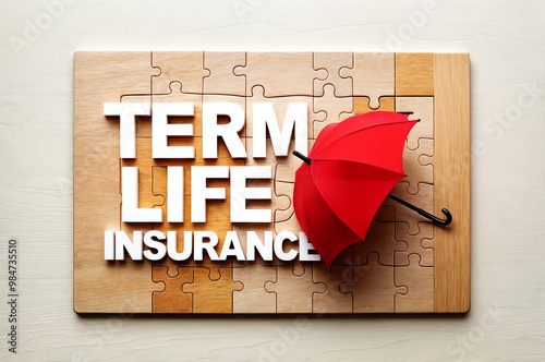 A wooden puzzle piece board with a word text term life insurance message in yellow letters and a red umbrella is placed on the board.