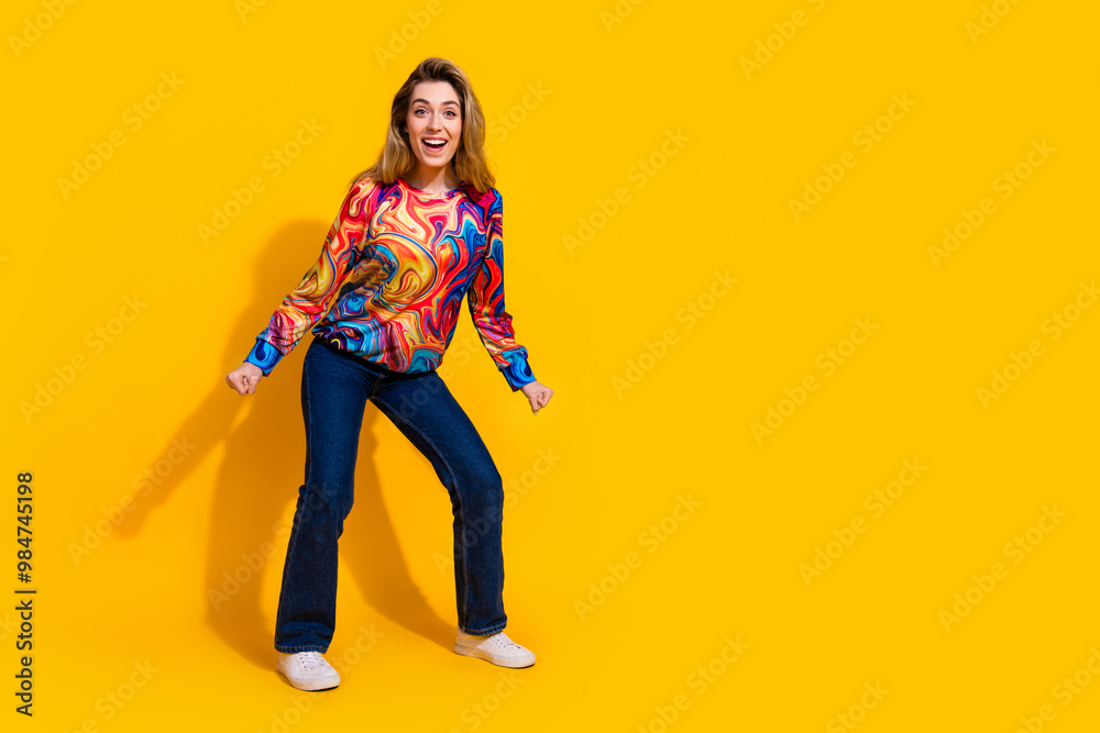 Photo portrait of young funny blonde hair attractive girl chill out dancer celebrating clothes sale isolated on yellow color background Photo portrait of young funny blonde hair attractive girl chill out dancer celebrating clothes sale isolated on yellow color background