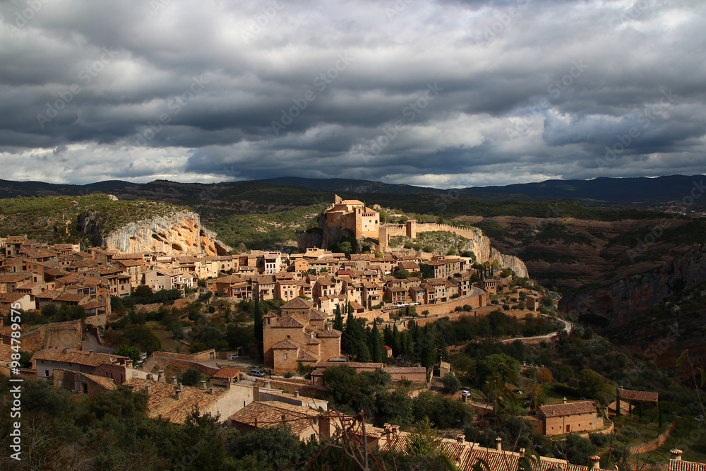 Panoramic view of the village of Alquezar and its castle under a threatening sky, late October (province of Huesca, autonomous community of Aragon, Spain). Panoramic view of the village of Alquezar and its castle under a threatening sky, late October (province of Huesca, autonomous community of Aragon, Spain).