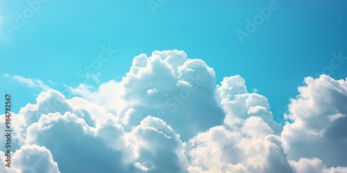 A captivating view of fluffy white clouds against a vibrant blue sky, radiating the beauty of a sunny day.