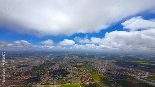 Panning footage of the vast territory divided on the diverse rectangular areas. PFV drone footage above the rural land with inhabited zones and farm lands. photo