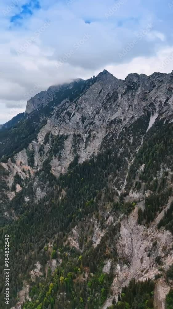 Stunning high rocks with some pine trees growing on surround urban landscape. Top view on Liechtenstein, Europe. FPV drone footage. Vertical video. Stunning high rocks with some pine trees growing on surround urban landscape. Top view on Liechtenstein, Europe. FPV drone footage. Vertical video.