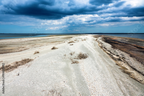 A bay bar, sand-shell spit in a shallow southern lagoon, onshore motion of sediments (cardium shells most), low tide, midsummer photo