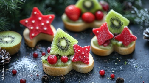 Christmas-themed fruit sandwiches with red and green fruits like strawberries and kiwis, shaped into festive trees and stars. photo