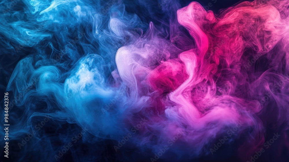 Obraz premium A dramatic swirl of colorful smoke in vibrant hues of pink, blue, and purple, creating an artistic and ethereal effect against a dark background.