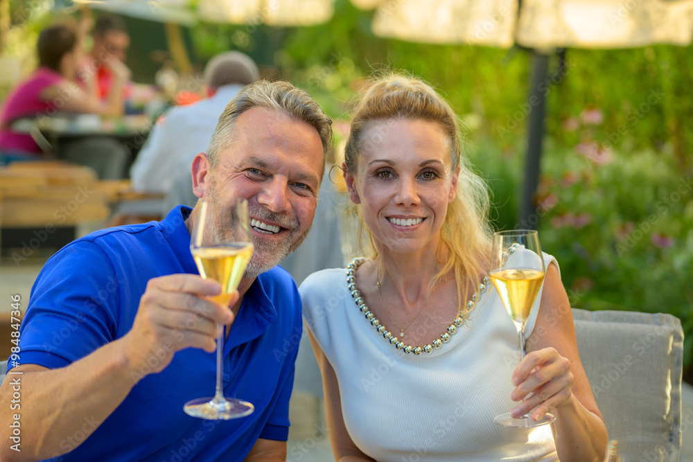 Happy Couple Toasting with Champagne Outdoors Happy Couple Toasting with Champagne Outdoors
