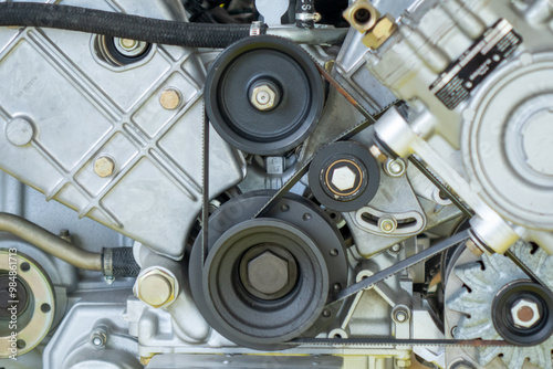 close up of a engine parts, belts and pulleys