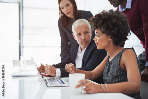 Collaboration, research and team director planning project with laptop, discussion and ideas. Brainstorming, diversity and business people for negotiation, work or communication in meeting in office