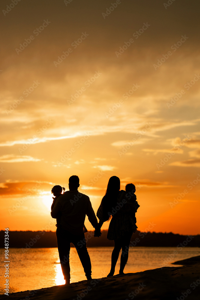 people on the river bank. happy family walking silhouette at sunset. mom dad and kids walking, happy family childhood dream concept. parents and kids walking back to the sun silhouette people on the river bank. happy family walking silhouette at sunset. mom dad and kids walking, happy family childhood dream concept. parents and kids walking back to the sun silhouette