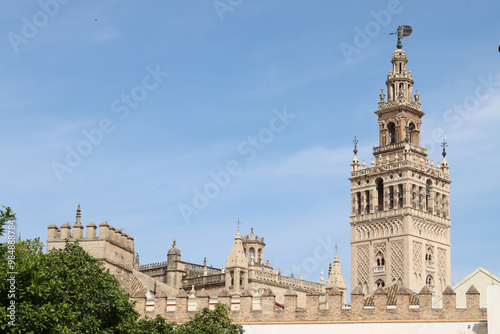 The giralda, bell tower of seville cathedral standing tall under blue sky