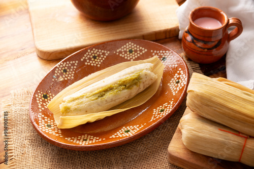 Tamales. hispanic dish typical of Mexico and some Latin American countries. Corn dough wrapped in corn leaves. The tamales are steamed.