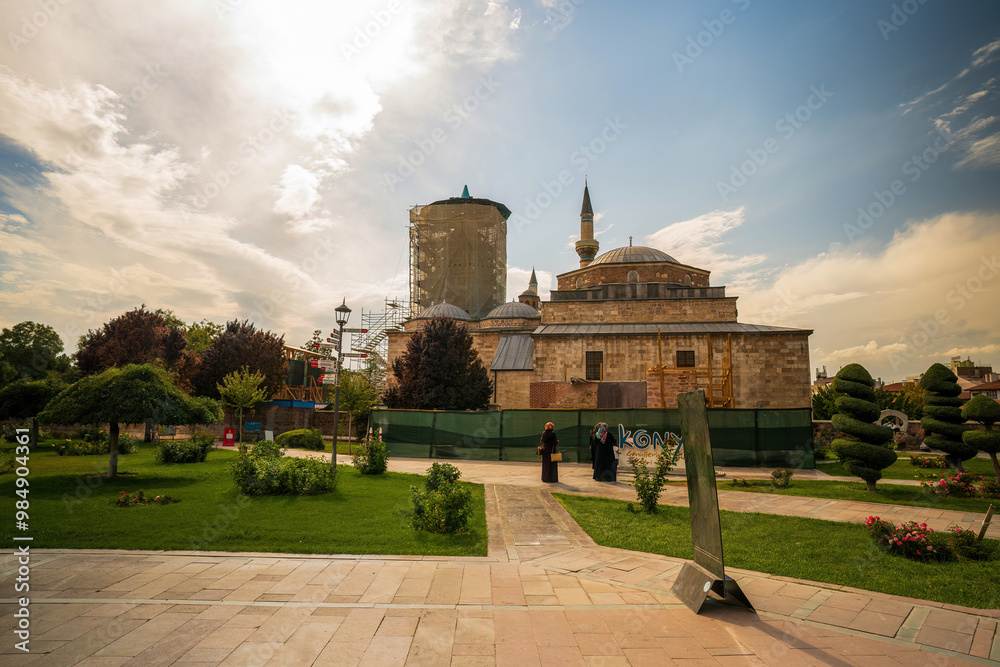 Konya, Turkey : Scenic view of the historic mosque in Konya, Turkey, highlighting its stunning architecture and tranquil garden setting under a bright blue sky.