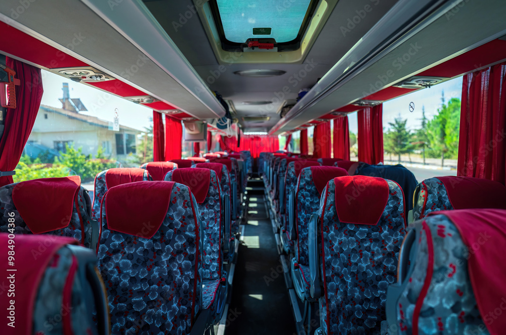 Interior Of An Empty Tourist Bus With Red Curtains