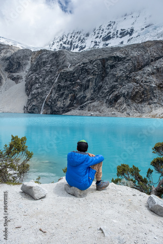 Child looking out over a lake of intense turquoise colours