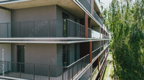 Modern residential or office building. under construction Wide angle shot from a drone. Large balconies with metal railings and glass.