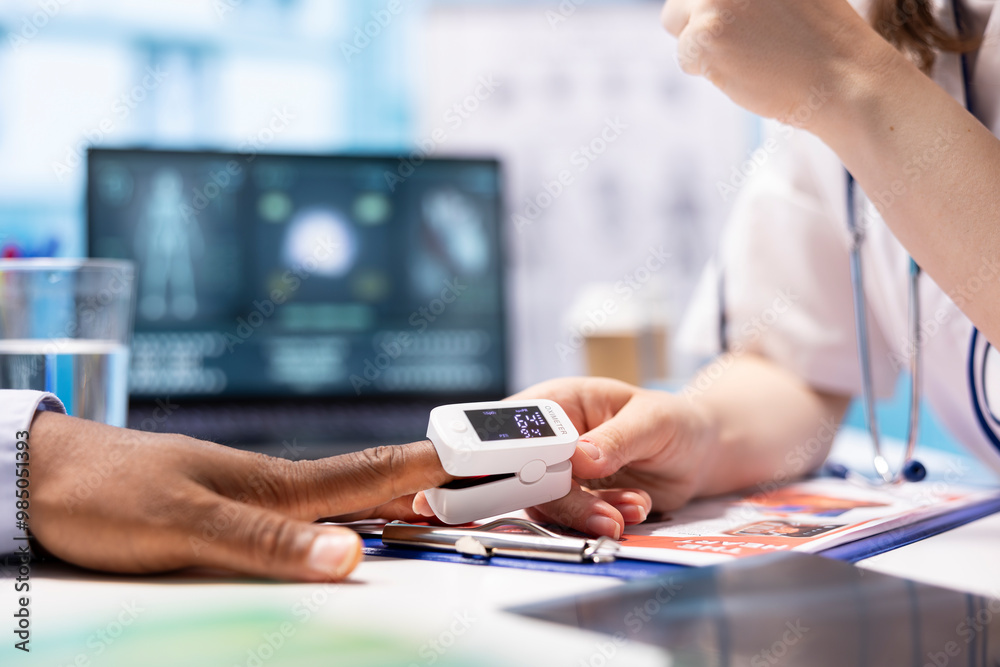Fototapeta premium Physician specialist placing an oximeter on patient finger to take oxygen levels and saturation measurement, monitoring pulse and vital signs. Professional medic consults on health insurance.