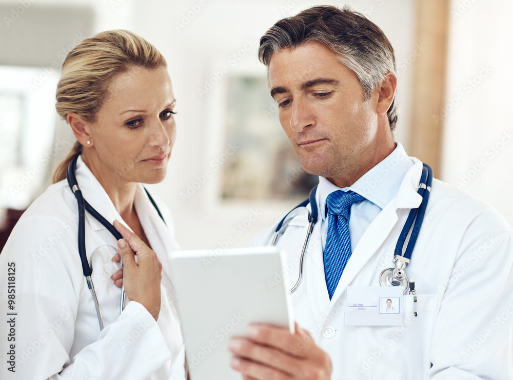 Doctors, man and woman with tablet, reading and thinking for research, telehealth and app. Mature people, partnership and digital touchscreen for healthcare, report or review for wellness in clinic Doctors, man and woman with tablet, reading and thinking for research, telehealth and app. Mature people, partnership and digital touchscreen for healthcare, report or review for wellness in clinic