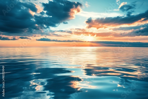 Peaceful ocean sunset with colorful clouds reflecting on the water surface