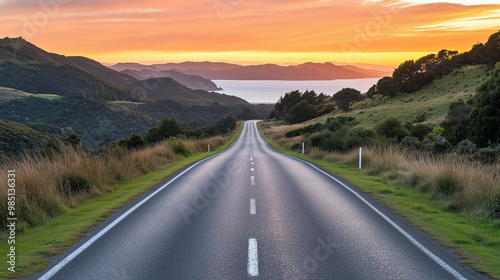 Low level view of empty old paved road in mountain area at sunset