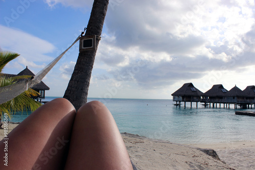 First person perspective of a woman's legs looking out to sea