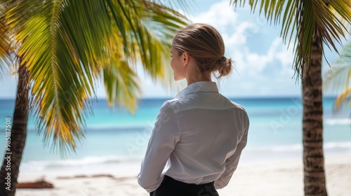 Fototapeta Naklejka Na Ścianę i Meble -  Ambitious businesswoman envisions dream getaway with tropical beach and palm trees in background