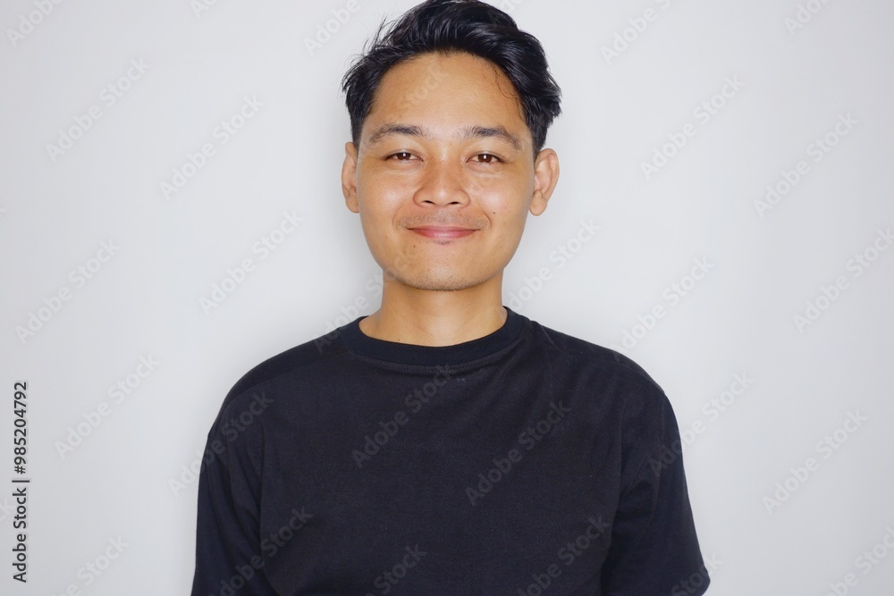 portrait of a handsome Indonesian man posing randomly wearing a black shirt on a white background isolated portrait of a handsome Indonesian man posing randomly wearing a black shirt on a white background isolated