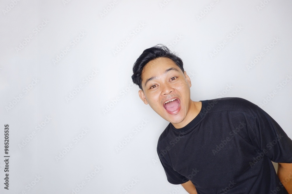 portrait of a handsome Indonesian man posing randomly wearing a black shirt on a white background isolated portrait of a handsome Indonesian man posing randomly wearing a black shirt on a white background isolated