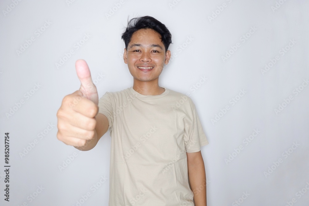 portrait of a handsome Indonesian man posing randomly wearing a Cream shirt on a white background isolated portrait of a handsome Indonesian man posing randomly wearing a Cream shirt on a white background isolated