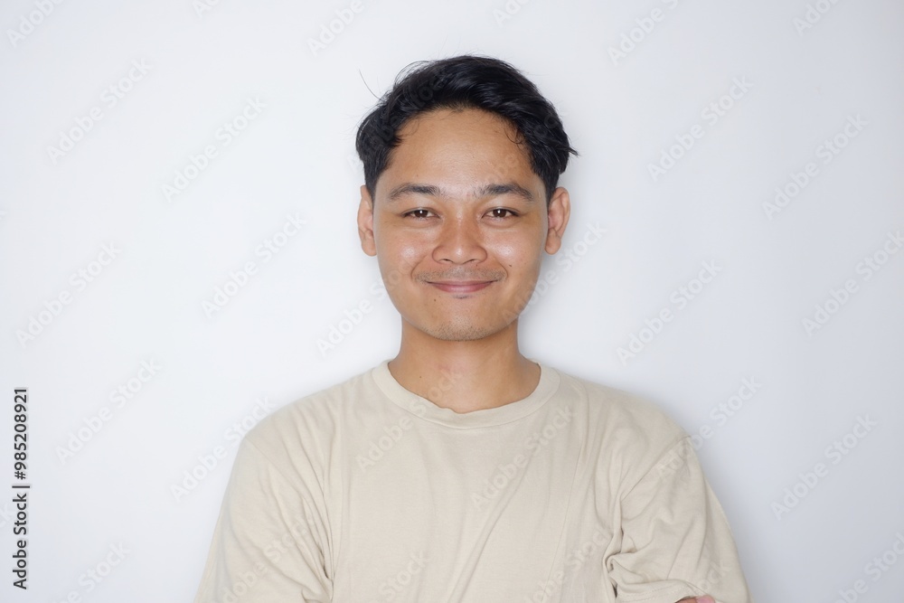 portrait of a handsome Indonesian man posing randomly wearing a Cream shirt on a white background isolated portrait of a handsome Indonesian man posing randomly wearing a Cream shirt on a white background isolated
