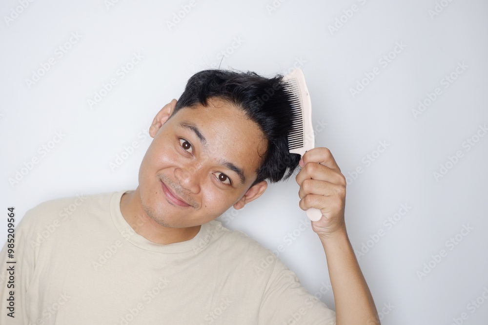 portrait of a handsome Indonesian man posing randomly wearing a Cream shirt on a white background isolated