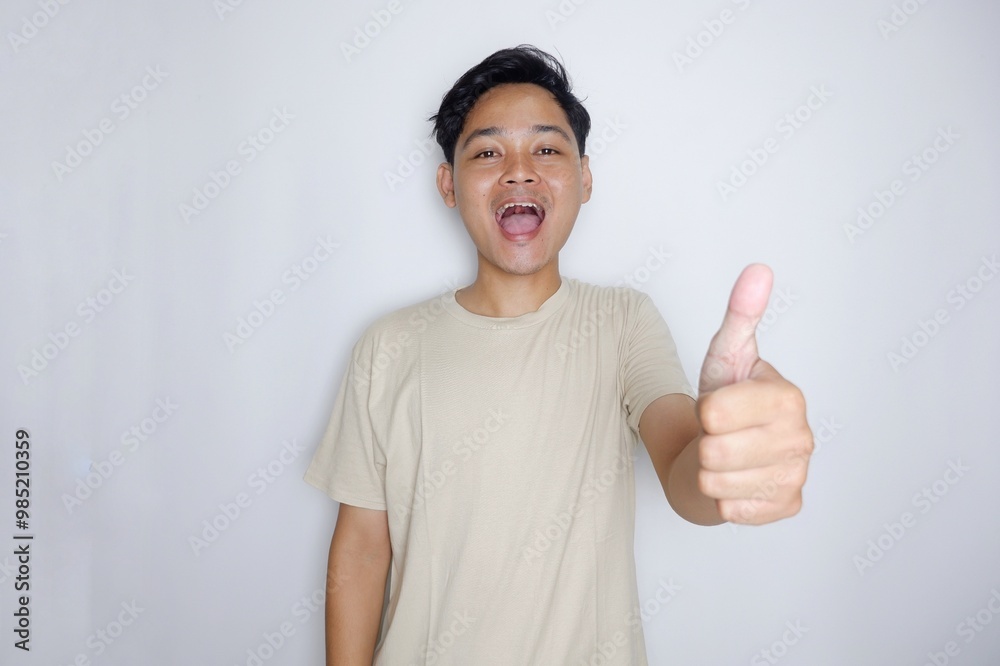 portrait of a handsome Indonesian man posing randomly wearing a Cream shirt on a white background isolated portrait of a handsome Indonesian man posing randomly wearing a Cream shirt on a white background isolated
