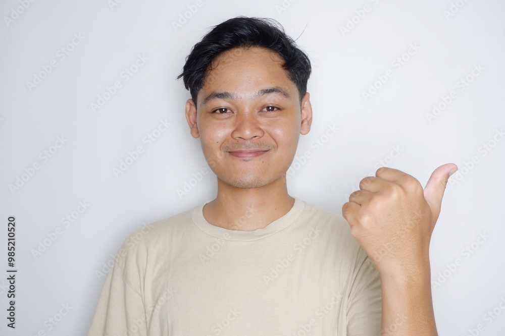 portrait of a handsome Indonesian man posing randomly wearing a Cream shirt on a white background isolated portrait of a handsome Indonesian man posing randomly wearing a Cream shirt on a white background isolated