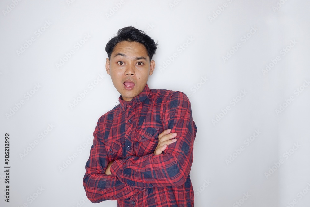 portrait of a handsome Indonesian man having a random expression wearing a checkered red flannel shirt on a white isolated background portrait of a handsome Indonesian man having a random expression wearing a checkered red flannel shirt on a white isolated background