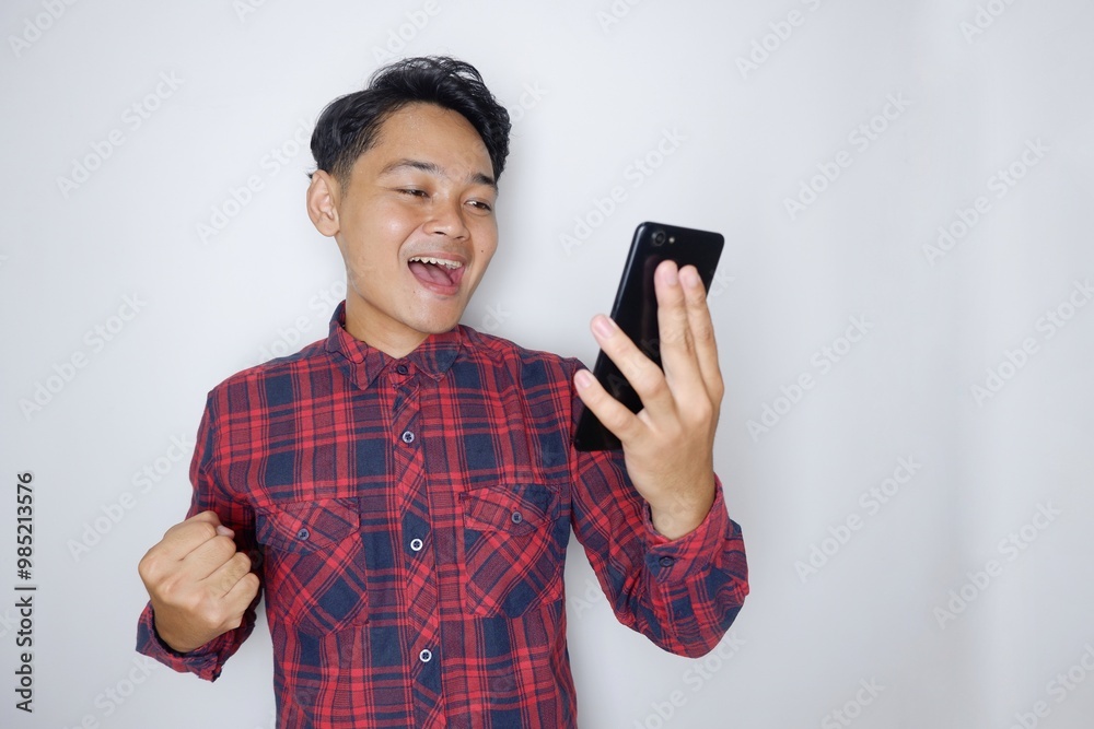 portrait of a handsome Indonesian man having a random expression wearing a checkered red flannel shirt on a white isolated background portrait of a handsome Indonesian man having a random expression wearing a checkered red flannel shirt on a white isolated background
