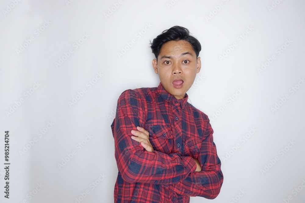 portrait of a handsome Indonesian man having a random expression wearing a checkered red flannel shirt on a white isolated background portrait of a handsome Indonesian man having a random expression wearing a checkered red flannel shirt on a white isolated background