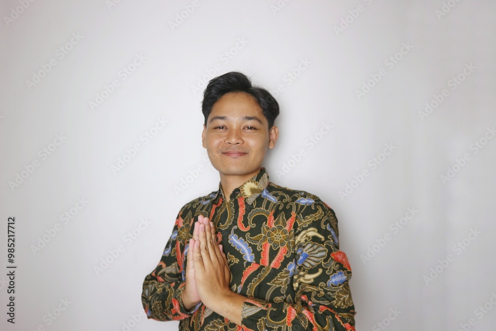 Handsome Indonesian man wearing batik with various expressions isolated white background Handsome Indonesian man wearing batik with various expressions isolated white background