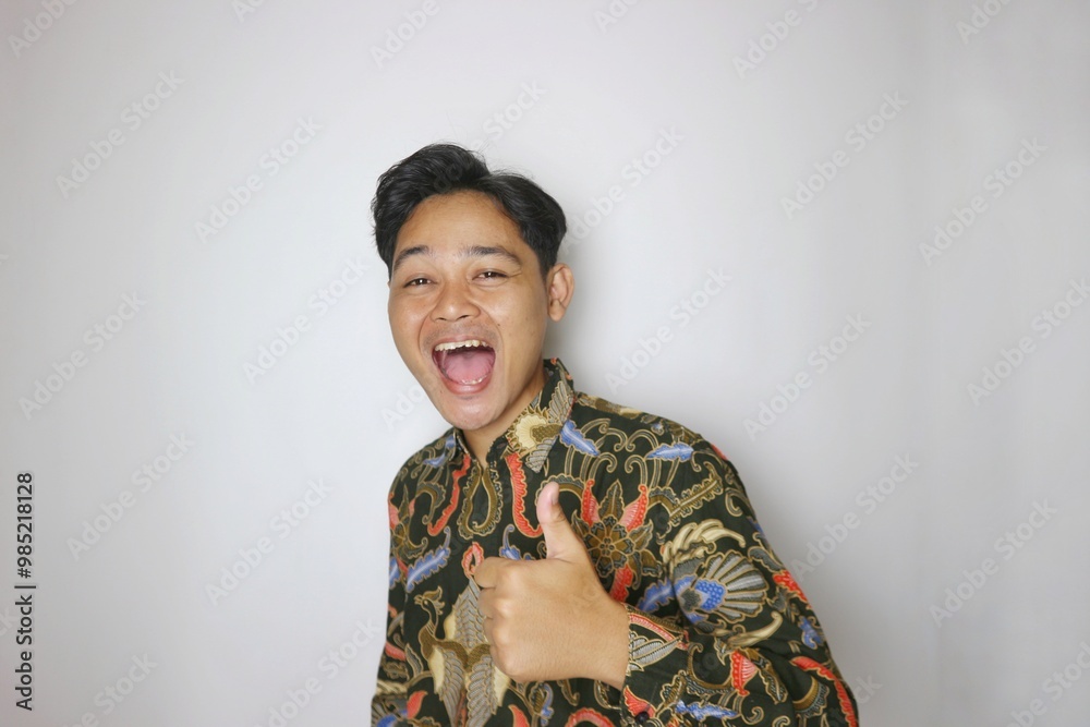Handsome Indonesian man wearing batik with various expressions isolated white background Handsome Indonesian man wearing batik with various expressions isolated white background