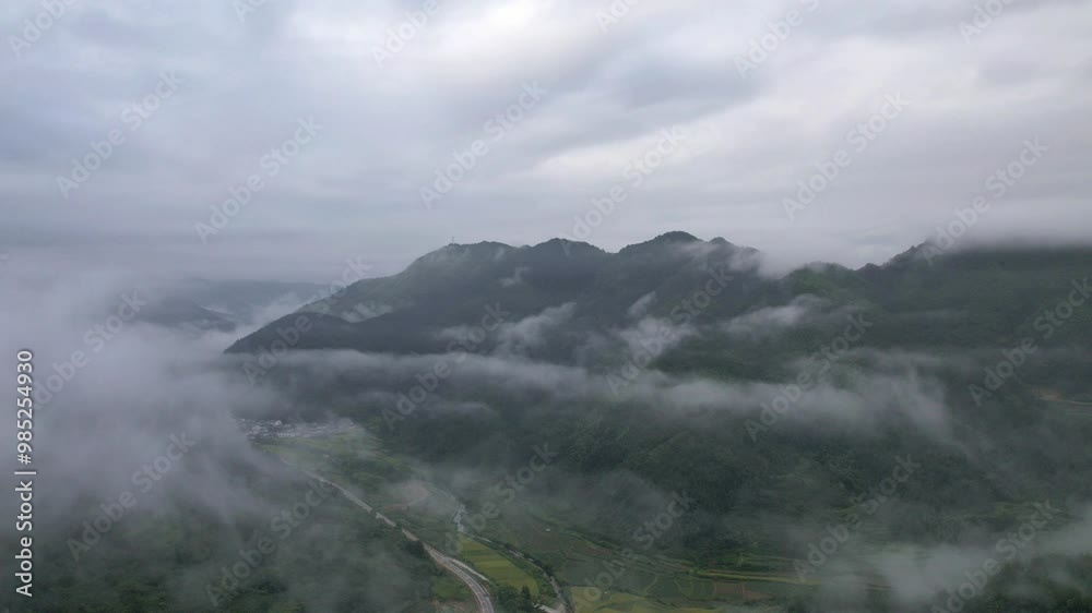 Hyper lapse drone view of villages and farmlands among green mountain valley, high angel view of clouds sea in morning, 4k time lapse footage b roll shot, Hongguan village, Wuyuan, Jiangxi, China