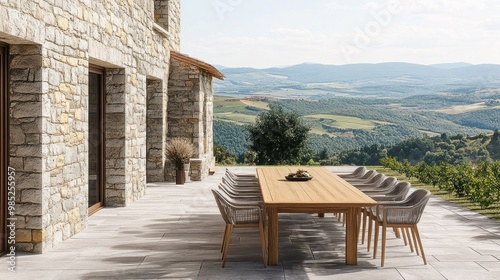 A serene outdoor dining area with a wooden table overlooking lush hills.