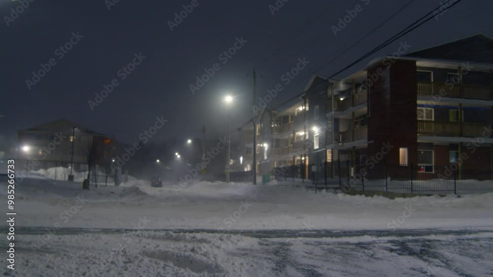 A Winter Storm Rages Through Dartmouth, Nova Scotia, At Night, Burying Cars And Buildings In Snow As Strong Winds Create A Powerful Blizzard. Canada 