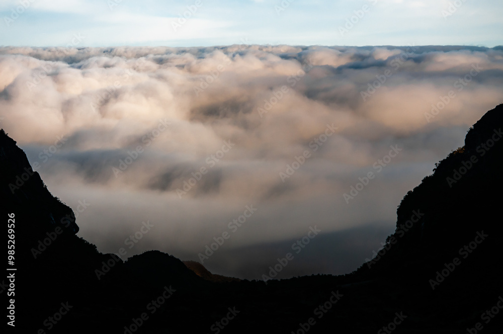 Obraz premium Silhouettes of mountain and vegetation on blue sky with beautiful clouds as space for writing that give a feeling of calm and sacred and tranquil heavenly paradise for the heart wallpaper or desktop