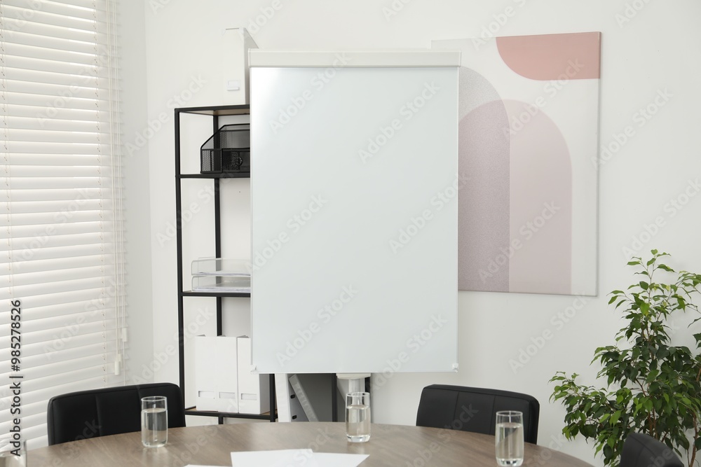 Flip chart, wooden table and chairs in conference room. Mockup for design Flip chart, wooden table and chairs in conference room. Mockup for design