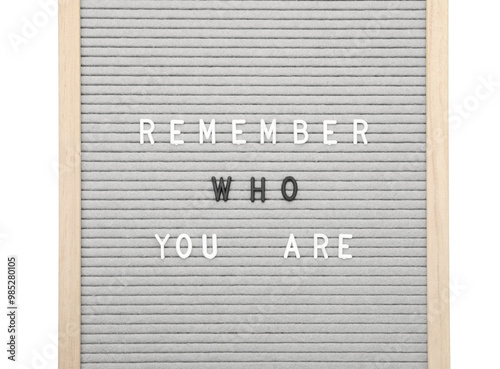 Letter board with phrase Remember who you are on white background, top view