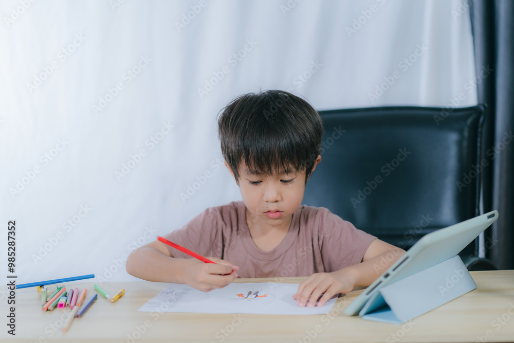 Education.Cute asian child boy learning and drawing with the online teacher on tablet digital at home. Education.Cute asian child boy learning and drawing with the online teacher on tablet digital at home.