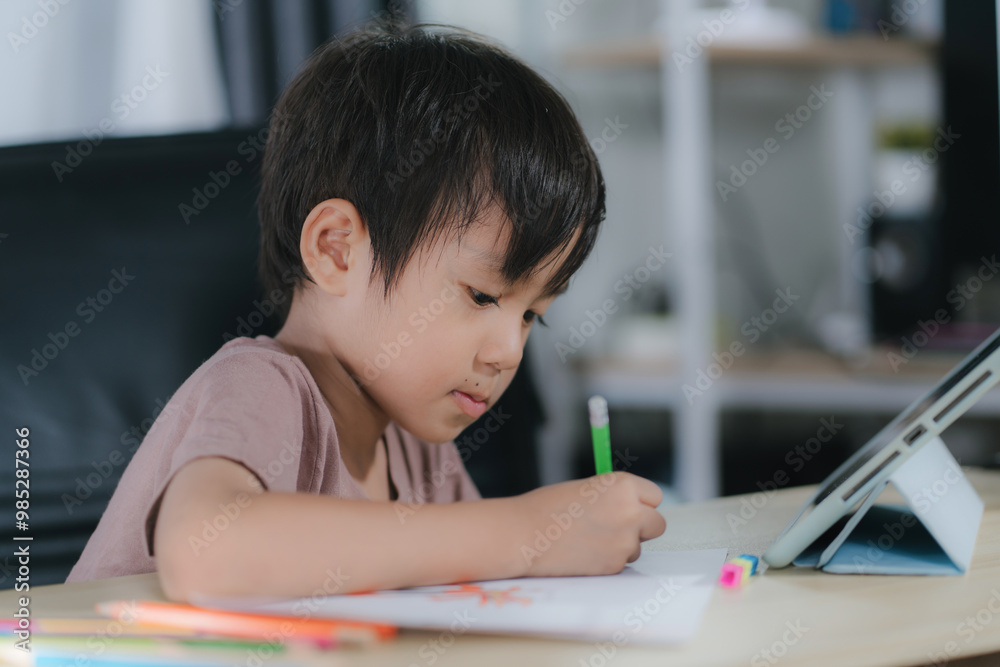 Education.Cute asian child boy learning and drawing with the online teacher on tablet digital at home. Education.Cute asian child boy learning and drawing with the online teacher on tablet digital at home.